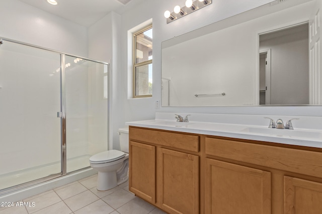 bathroom with a shower with shower door, tile patterned flooring, toilet, and double sink vanity