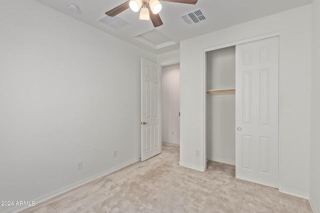 unfurnished bedroom featuring light carpet, a closet, and ceiling fan