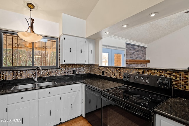 kitchen with pendant lighting, sink, dark stone countertops, black appliances, and white cabinets