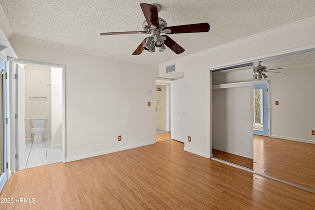 unfurnished bedroom featuring crown molding, light hardwood / wood-style flooring, a textured ceiling, a closet, and ceiling fan