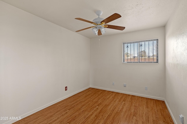 spare room featuring hardwood / wood-style flooring, ceiling fan, and a textured ceiling