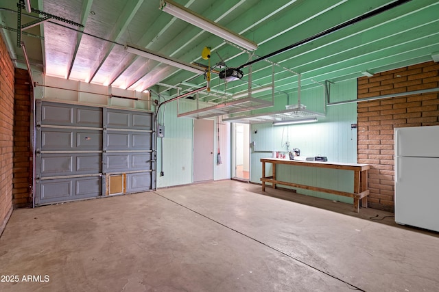 garage with white refrigerator and a garage door opener