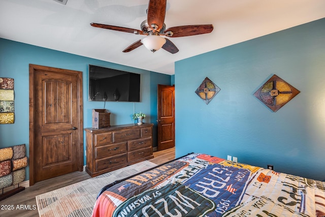 bedroom featuring a ceiling fan and wood finished floors