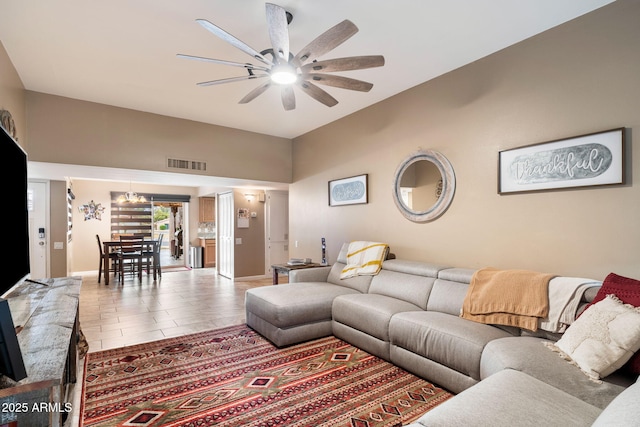 living room with ceiling fan and tile patterned flooring