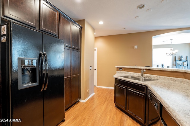 kitchen featuring black appliances, sink, hanging light fixtures, light hardwood / wood-style floors, and dark brown cabinetry