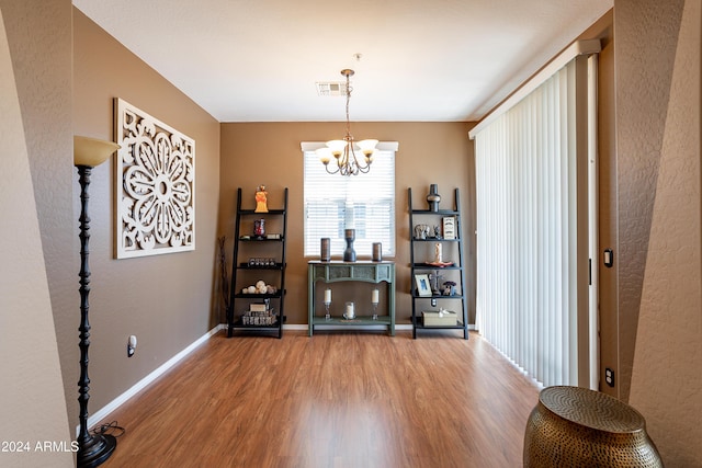 interior space with a chandelier and wood-type flooring