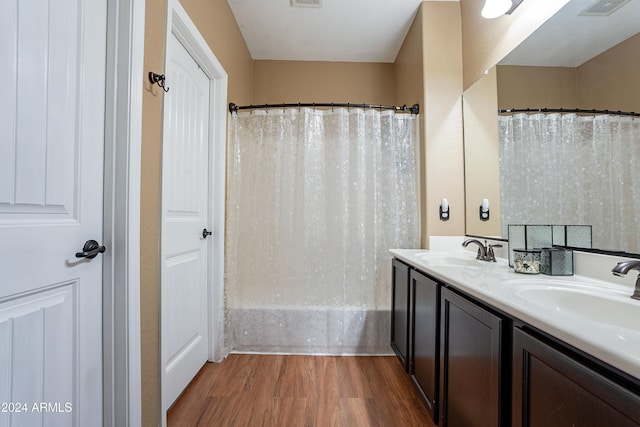 bathroom with curtained shower, vanity, and wood-type flooring