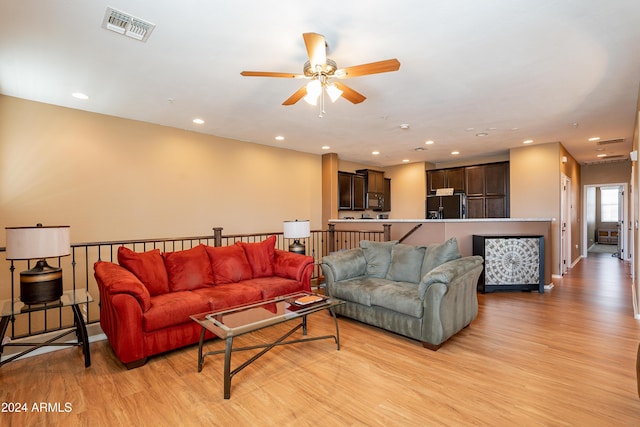 living room with light wood-type flooring and ceiling fan