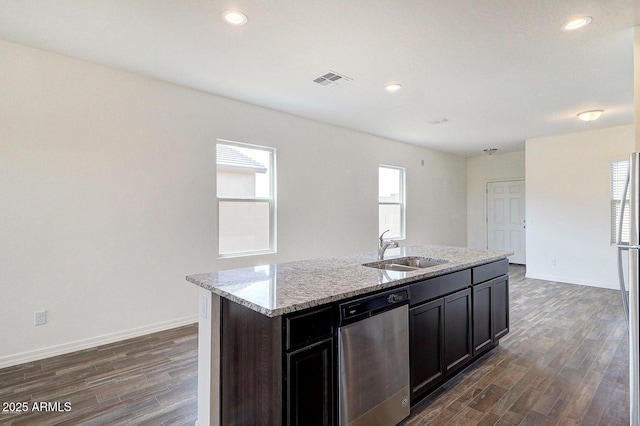 kitchen featuring dishwasher, dark wood finished floors, visible vents, and a sink