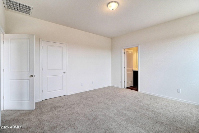 unfurnished bedroom with visible vents, baseboards, and carpet flooring