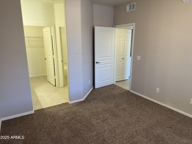 1941 S Pierpont Dr Unit 1043, Mesa, AZ 85206 - unfurnished bedroom featuring carpet flooring, a closet, and a spacious closet
