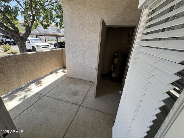1941 S Pierpont Dr Unit 1043, Mesa, AZ 85206 - doorway to property with electric water heater, a balcony, and stucco siding