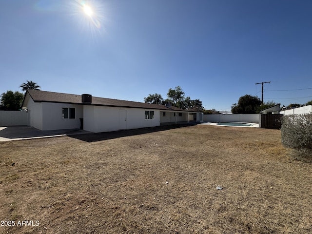 exterior space with a fenced in pool and a front lawn