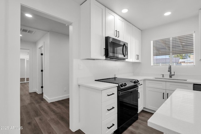 kitchen with white cabinetry, black range with electric stovetop, dark hardwood / wood-style flooring, and sink