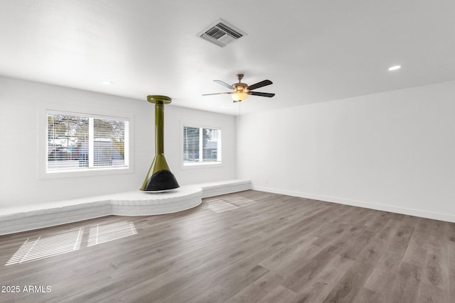 unfurnished living room featuring hardwood / wood-style floors and ceiling fan