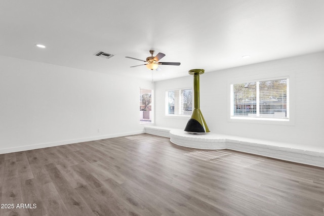 unfurnished living room with ceiling fan and wood-type flooring