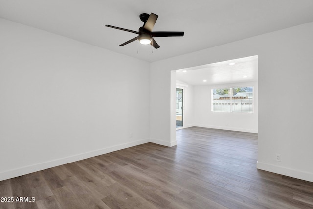 empty room with ceiling fan and wood-type flooring