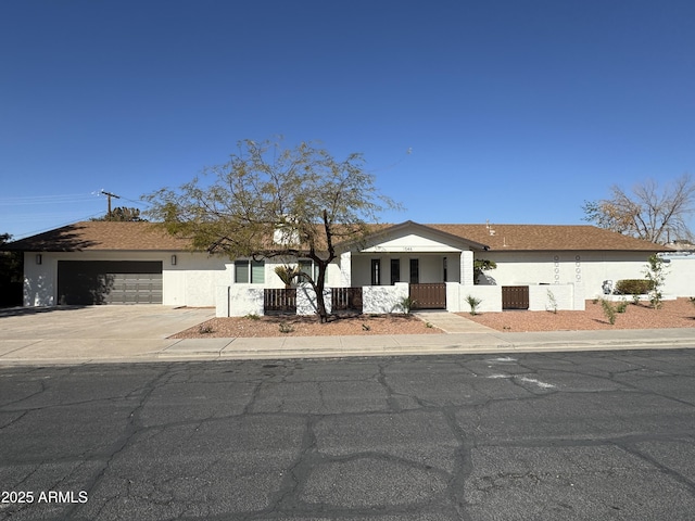 single story home with central AC unit and a garage