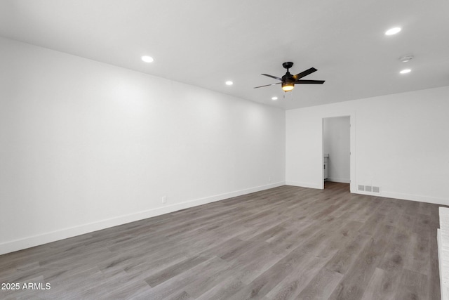 unfurnished room with ceiling fan and light wood-type flooring