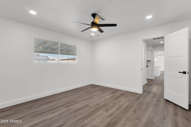 spare room with ceiling fan and wood-type flooring