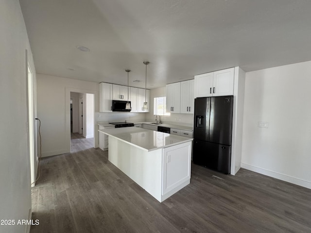 kitchen featuring a kitchen island, dark hardwood / wood-style floors, white cabinets, hanging light fixtures, and black appliances