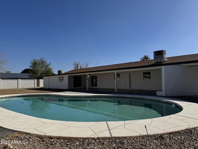 view of swimming pool featuring cooling unit and a patio