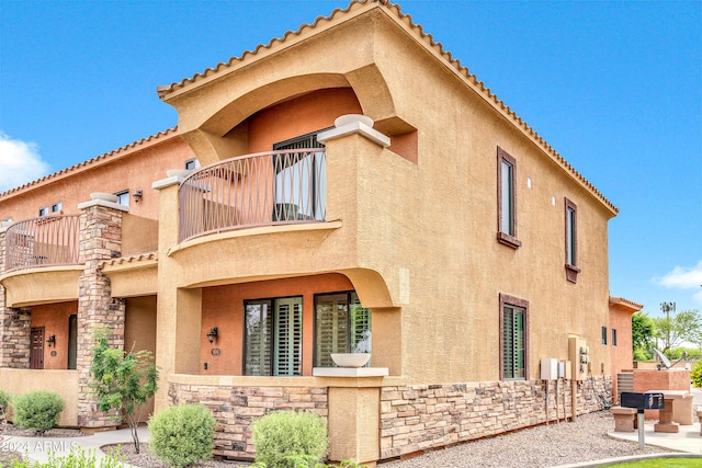 rear view of property featuring a balcony