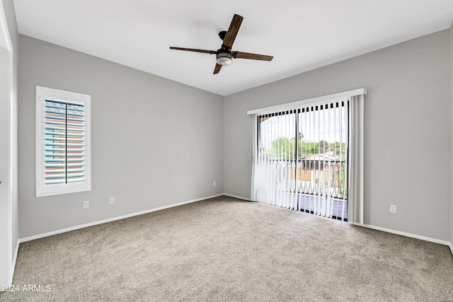 carpeted empty room featuring ceiling fan