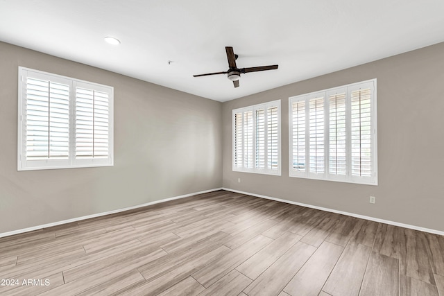 spare room with ceiling fan and light hardwood / wood-style flooring