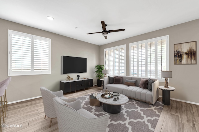 living room with hardwood / wood-style floors and ceiling fan