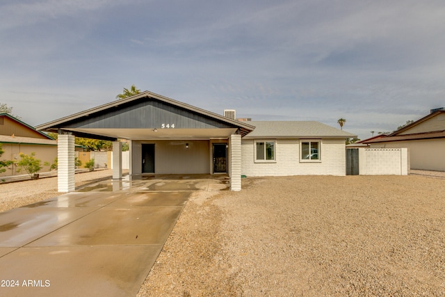 ranch-style home featuring a carport