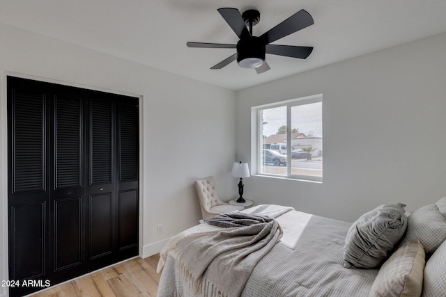 bedroom featuring ceiling fan, a closet, and hardwood / wood-style flooring