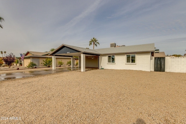 ranch-style house featuring a carport