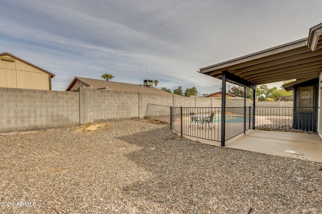 view of yard featuring a patio area and a fenced in pool