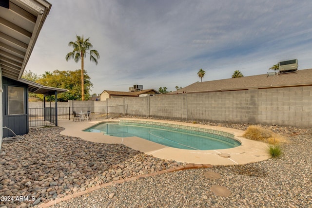 view of swimming pool with central AC and a patio