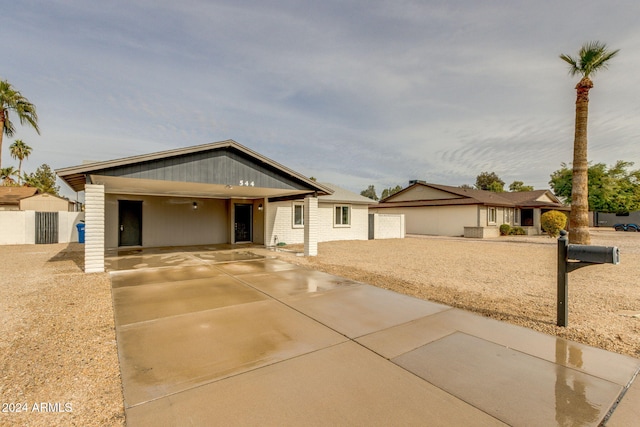 ranch-style house featuring a carport