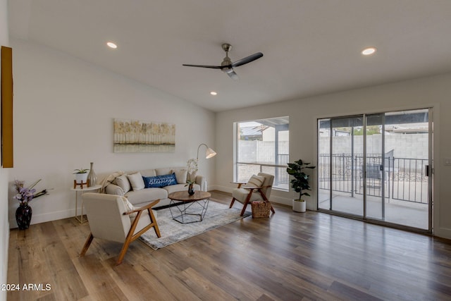 living room with hardwood / wood-style floors, ceiling fan, and vaulted ceiling