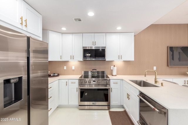 3150 E Beardsley Rd Unit 1081, Phoenix, AZ 85050 - kitchen with stainless steel appliances, white cabinetry, light countertops, a peninsula, and recessed lighting