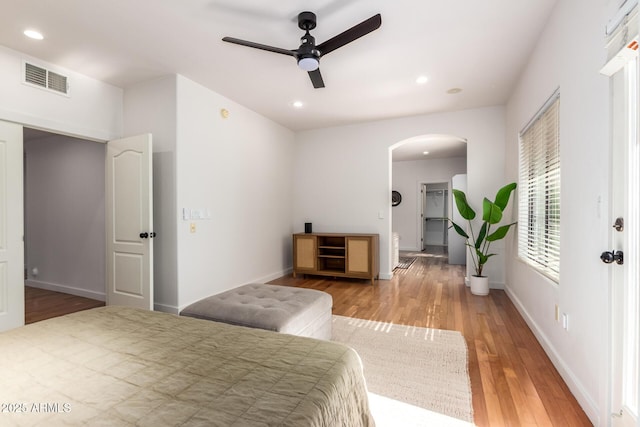3150 E Beardsley Rd Unit 1081, Phoenix, AZ 85050 - bedroom featuring arched walkways, light wood-type flooring, recessed lighting, and a ceiling fan