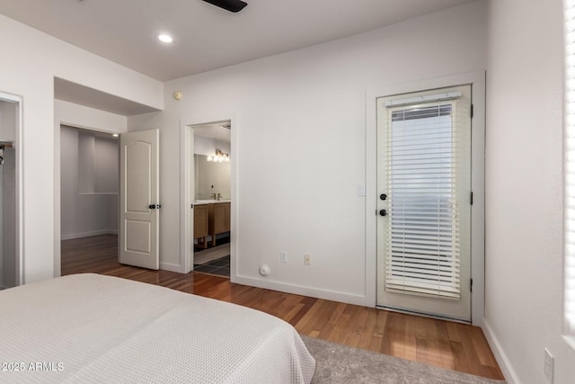 3150 E Beardsley Rd Unit 1081, Phoenix, AZ 85050 - bedroom with wood finished floors, ensuite bathroom, and access to exterior