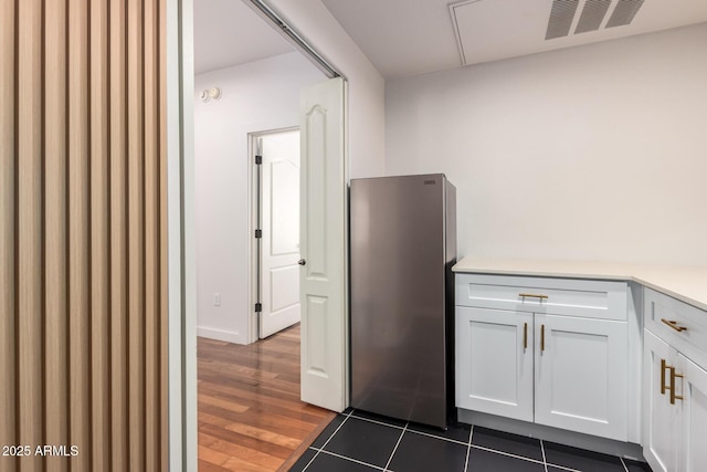 3150 E Beardsley Rd Unit 1081, Phoenix, AZ 85050 - kitchen featuring freestanding refrigerator, white cabinetry, light countertops, and dark wood-style flooring