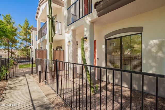 3150 E Beardsley Rd Unit 1081, Phoenix, AZ 85050 - view of exterior entry featuring a balcony, stucco siding, and a gate