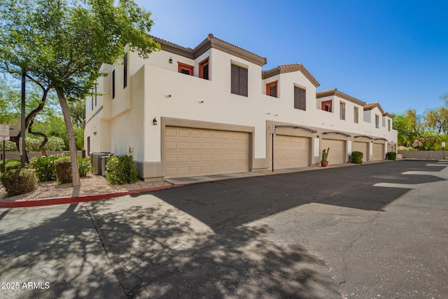 3150 E Beardsley Rd Unit 1081, Phoenix, AZ 85050 - view of front of home with stucco siding, an attached garage, and a tiled roof