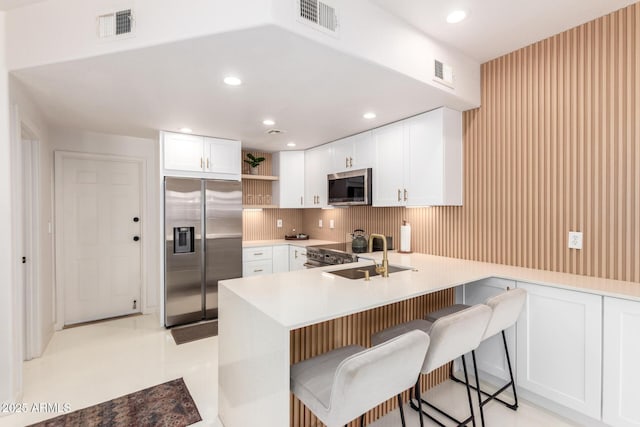 3150 E Beardsley Rd Unit 1081, Phoenix, AZ 85050 - kitchen with stainless steel appliances, open shelves, a peninsula, white cabinets, and recessed lighting