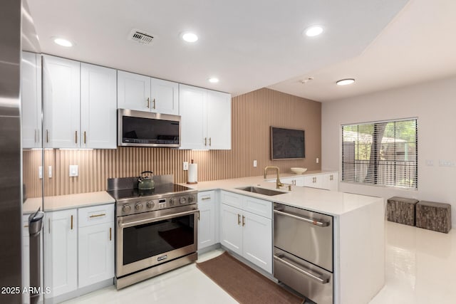 3150 E Beardsley Rd Unit 1081, Phoenix, AZ 85050 - kitchen with appliances with stainless steel finishes, a peninsula, white cabinetry, light countertops, and recessed lighting