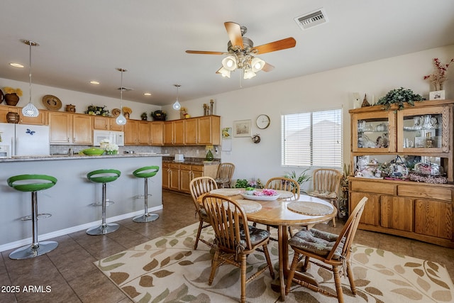 tiled dining area with lofted ceiling and ceiling fan