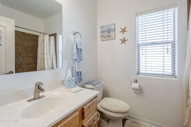 bathroom featuring vanity, toilet, and a shower with shower curtain