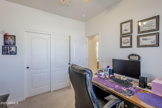 carpeted office space featuring ceiling fan