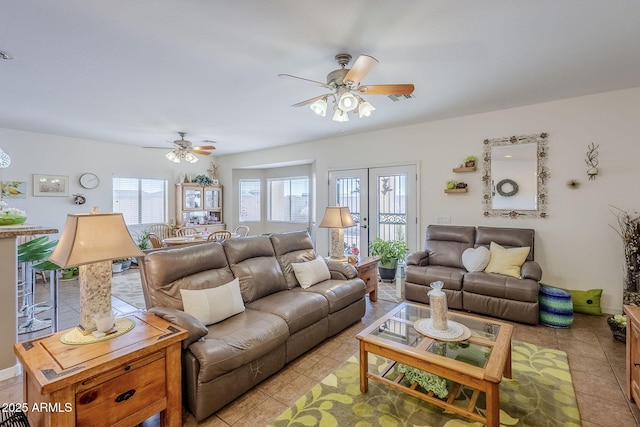 tiled living room with french doors and ceiling fan