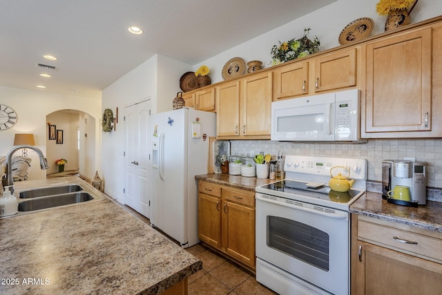 kitchen with light brown cabinetry, tasteful backsplash, sink, dark tile patterned floors, and white appliances